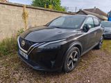 the black nissan qx parked in front of a stone wall