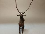 bronze sculpture of a deer with antlers on it ' s head