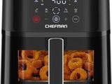 a black air fryer filled with fried donuts on a white background
