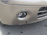 a close up of the front of a car with a dent in it
