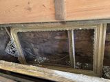 a window in the wall of a room that needs to be repaired