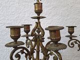 brass candelabra with five candles on a wooden table