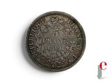 a close up of a coin on a white surface