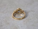a close up of a gold ring with a diamond on it