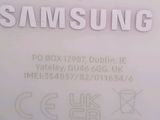 the back of a white samsung phone with the samsung logo on it