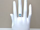 a white mannequin hand with a blue ring on it