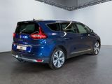 the rear end of a blue car parked in a garage