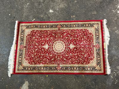 a red rug with a medallion design on it