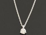 a silver necklace with a small diamond on a chain