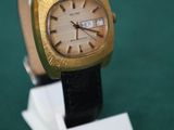 a watch that is sitting on a stand on a green surface
