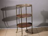 a three tiered table on a tiled floor