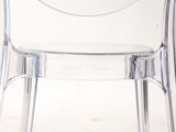 a clear plastic chair with a clock on the back of it