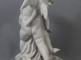 statue of an angel holding a child on a pedestal