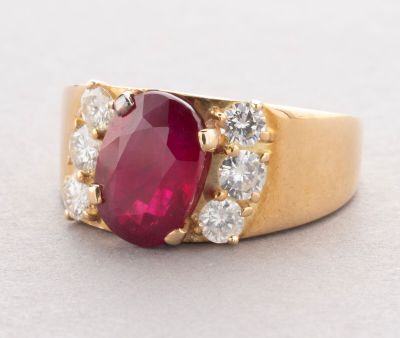 an image of a close up of a ring with a red stone