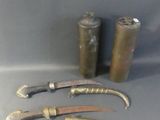 three knives and a canister are sitting on a table