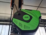 a green and black machine that is hanging from the ceiling