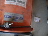 a close up of a gas can with a hose attached to it
