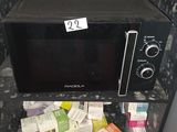 a microwave that is sitting on a shelf in the corner of a room