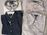 two men ' s shirts are wrapped in plastic bags on a table