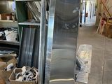 a refrigerator in the middle of a warehouse filled with assorted items
