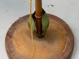 a lamp that is on top of a wooden stand