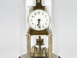 a glass dome with a clock inside of it