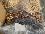 many bags of nuts on a carton in the store