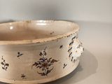 a white bowl with blue flowers on it on a table