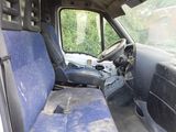 the interior of a van with a blue seat cover and a steering wheel
