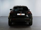 the back end of a black car in a white room
