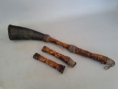 three wooden sticks that are laying on a white surface