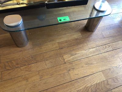une table basse en verre avec un plateau en verre et un piètement en métal