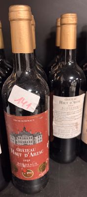 bottles of wine are lined up on a shelf in a wine cellar