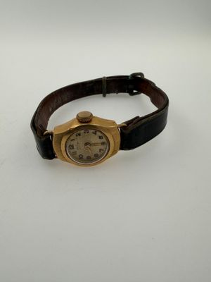 a close up of a wrist watch on a white surface