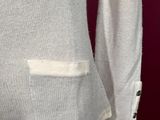 a close up of a white sweater with buttons on a mannequin mannequin mannequin mannequin mannequin mannequin mannequin