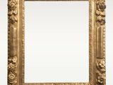 an antique gold frame with flowers and leaves on a white background