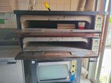 a microwave sitting on top of a stove in a kitchen