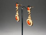 a pair of coral and pearl earrings