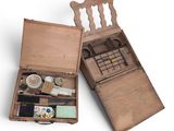 an old wooden box with a bunch of items inside of it