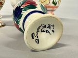 three vases with different designs on them sitting on a table