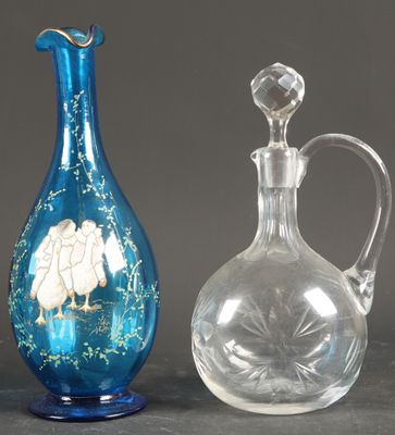 two glass vases sitting next to each other on top of a table