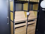 une grande armoire en bois avec des tiroirs et des étagères, dans une pièce