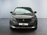the front view of a grey car parked in a showroom