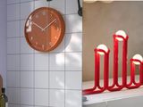 a clock that is on the wall next to some candles