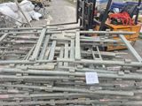 a forklift that is parked next to a pile of pipes