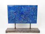 sculpture of a blue painting on a metal stand on a white background