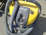 a yellow and black vacuum sitting on the ground
