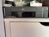 an image of a compact cd player sitting on top of a cabinet