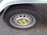 a close up of a tire with a yellow sticker on it