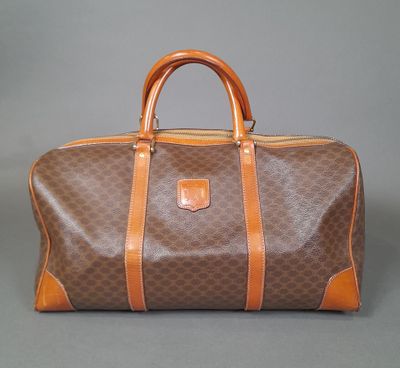 an image of a brown and tan duffel bag on a grey background